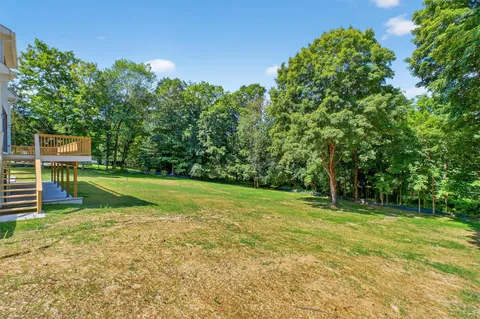 a view of a backyard with swimming pool