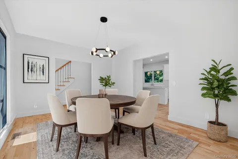 a large white kitchen with kitchen island granite countertop a large window