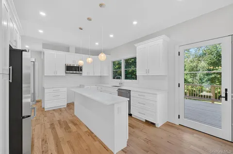 a view of livingroom with furniture wooden floor and windows