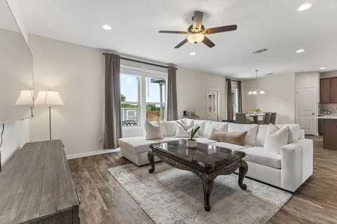 a dining room with furniture a chandelier and a rug