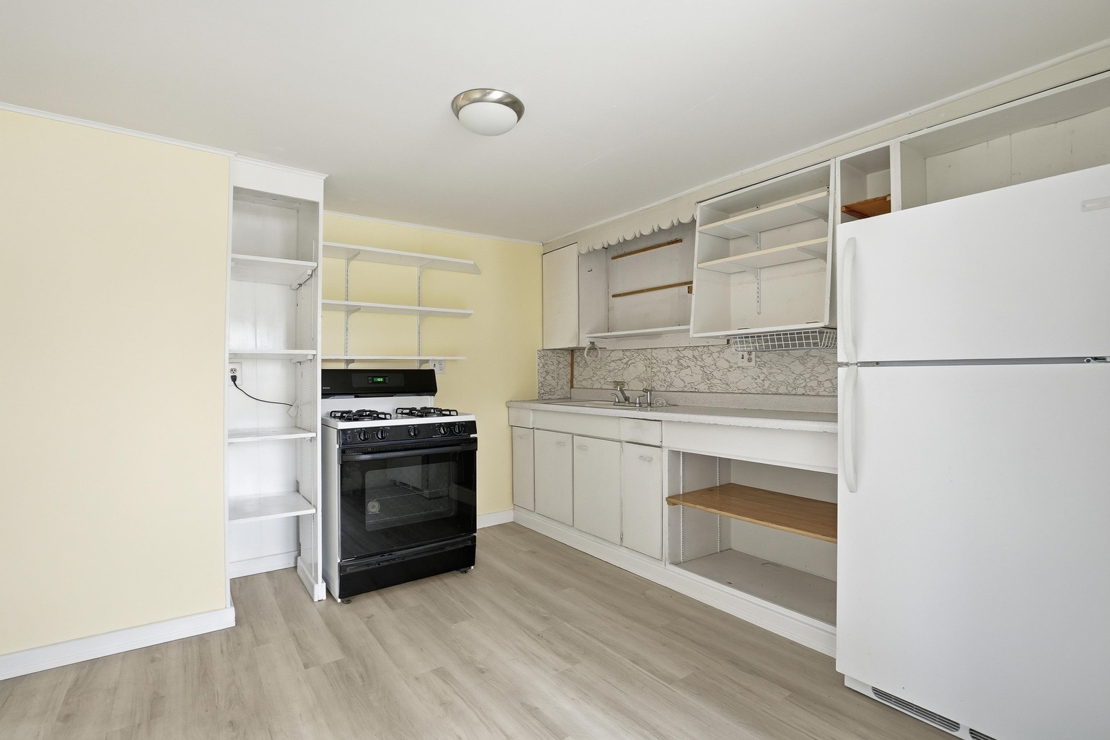 910 18th Avenue Rock Island, IL 61201 - Photo 7 of 30 a kitchen with a cabinets and white appliances
