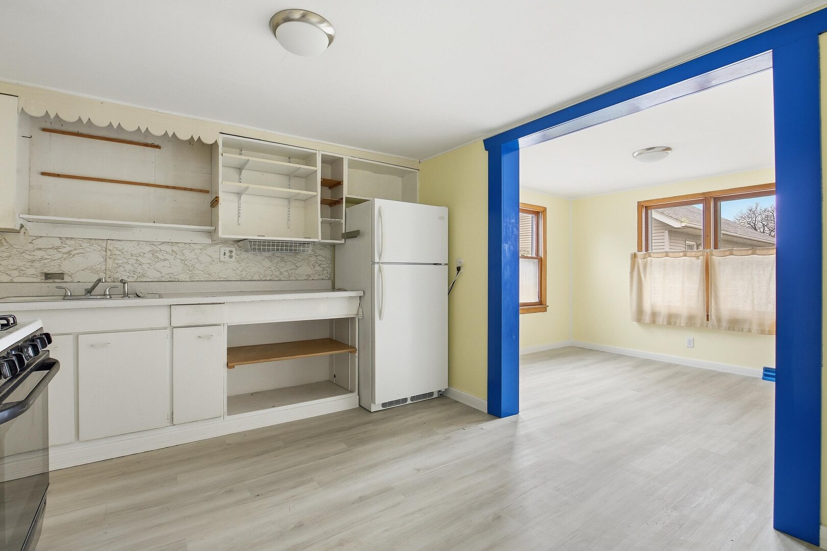 910 18th Avenue Rock Island, IL 61201 - Photo 9 of 30 a kitchen with a refrigerator and white cabinets
