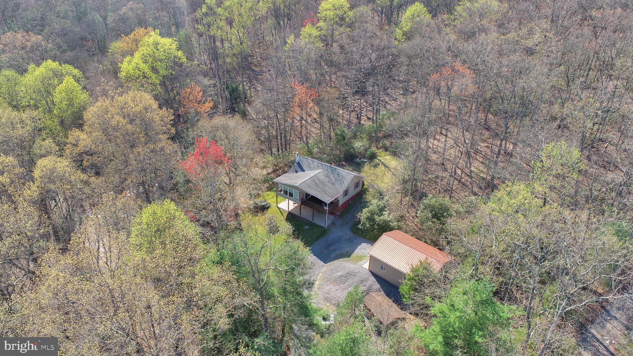 a aerial view of a house with a yard and tree s