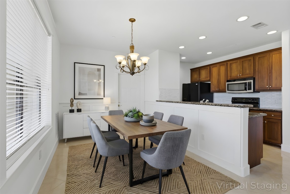 17700 Edgewood Way, Unit 101 Jonestown, TX 78645 - Photo 11 of 40 a dining room filled chandelier and kitchen view