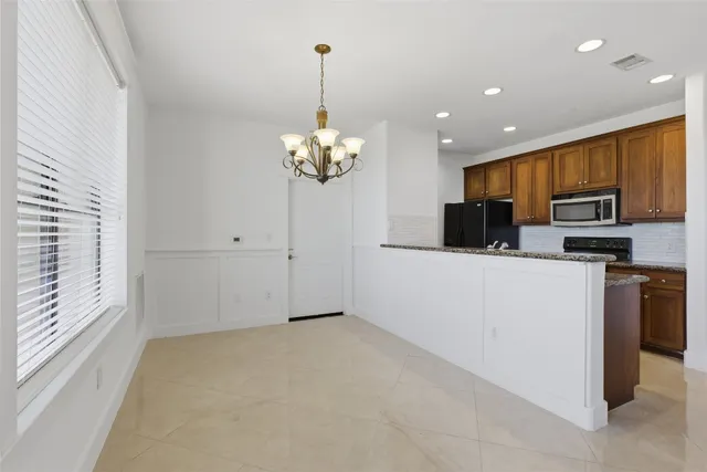 a view of a kitchen with microwave and cabinets