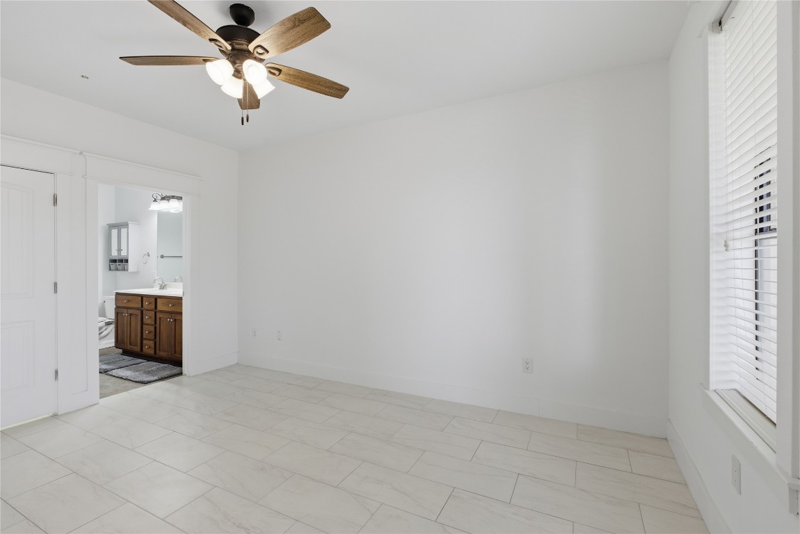 17700 Edgewood Way, Unit 101 Jonestown, TX 78645 - Photo 14 of 40 an empty room with windows and fan
