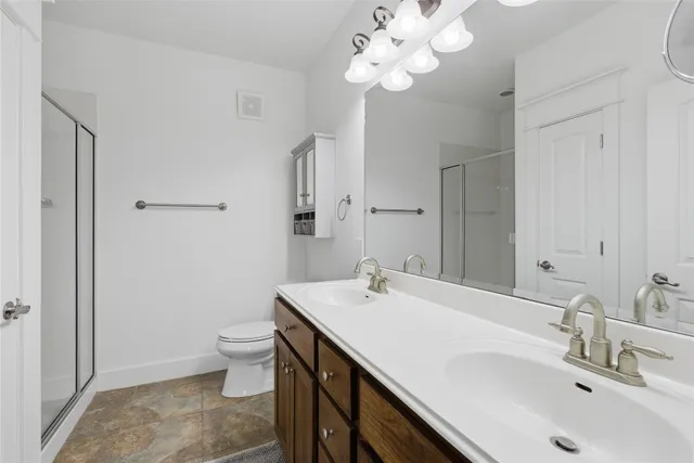 a bathroom with a sink a toilet and a mirror
