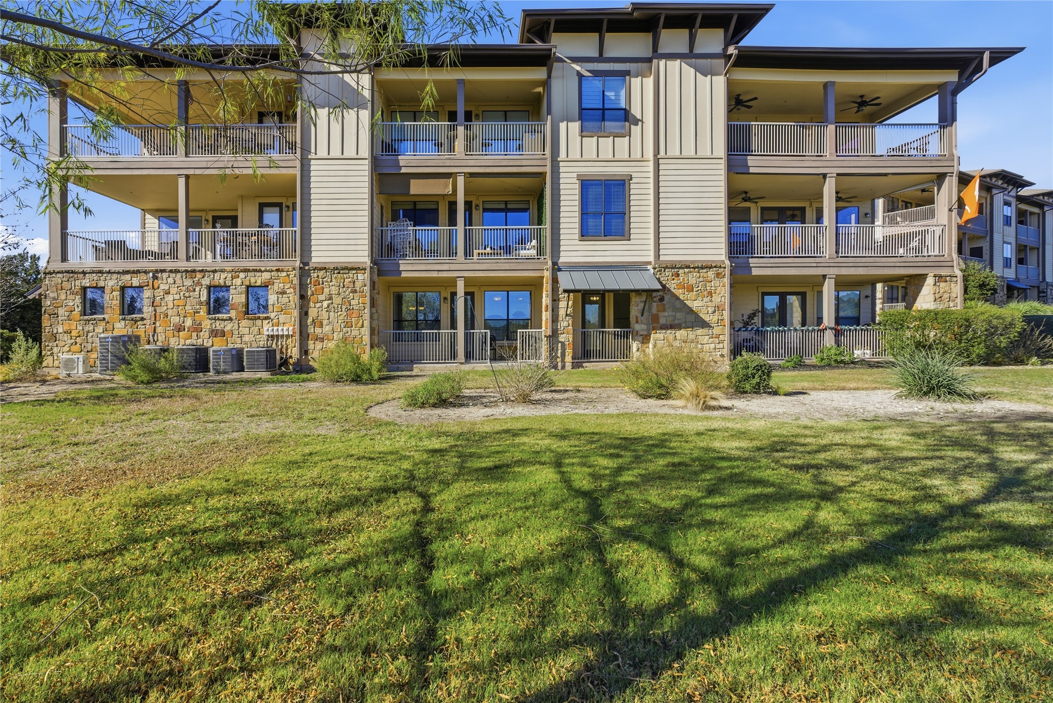 17700 Edgewood Way, Unit 101 Jonestown, TX 78645 - Photo 26 of 40 a front view of a building with a garden
