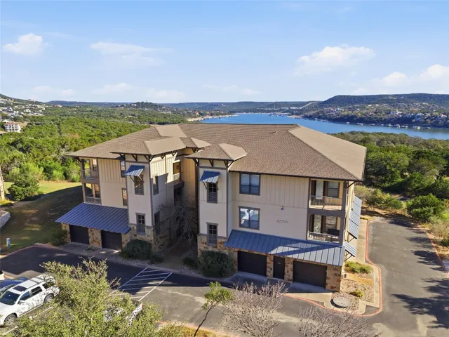 an aerial view of a house with a yard garage and a patio