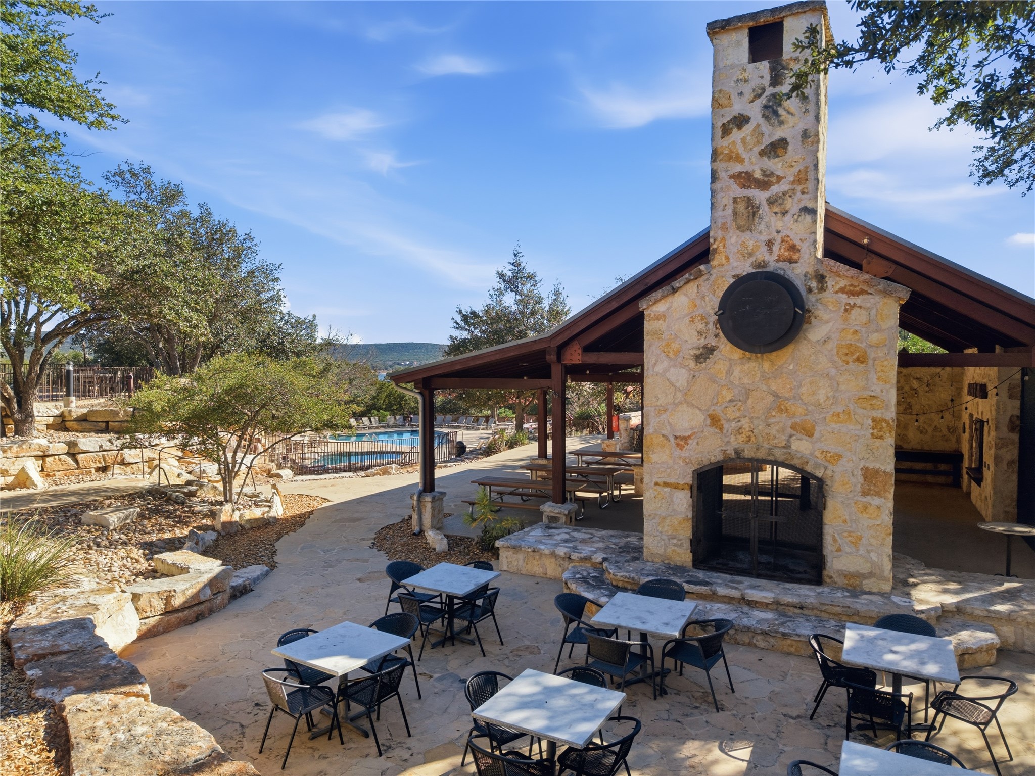 17700 Edgewood Way, Unit 101 Jonestown, TX 78645 - Photo 33 of 40 a roof deck with table and chairs and potted plants