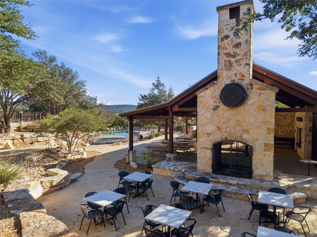 17700 Edgewood Way, Unit 101 Jonestown, TX 78645 - Photo 33 of 40 a roof deck with table and chairs and potted plants