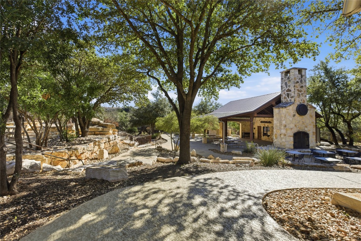 17700 Edgewood Way, Unit 101 Jonestown, TX 78645 - Photo 34 of 40 a view of a house with a yard covered in snow