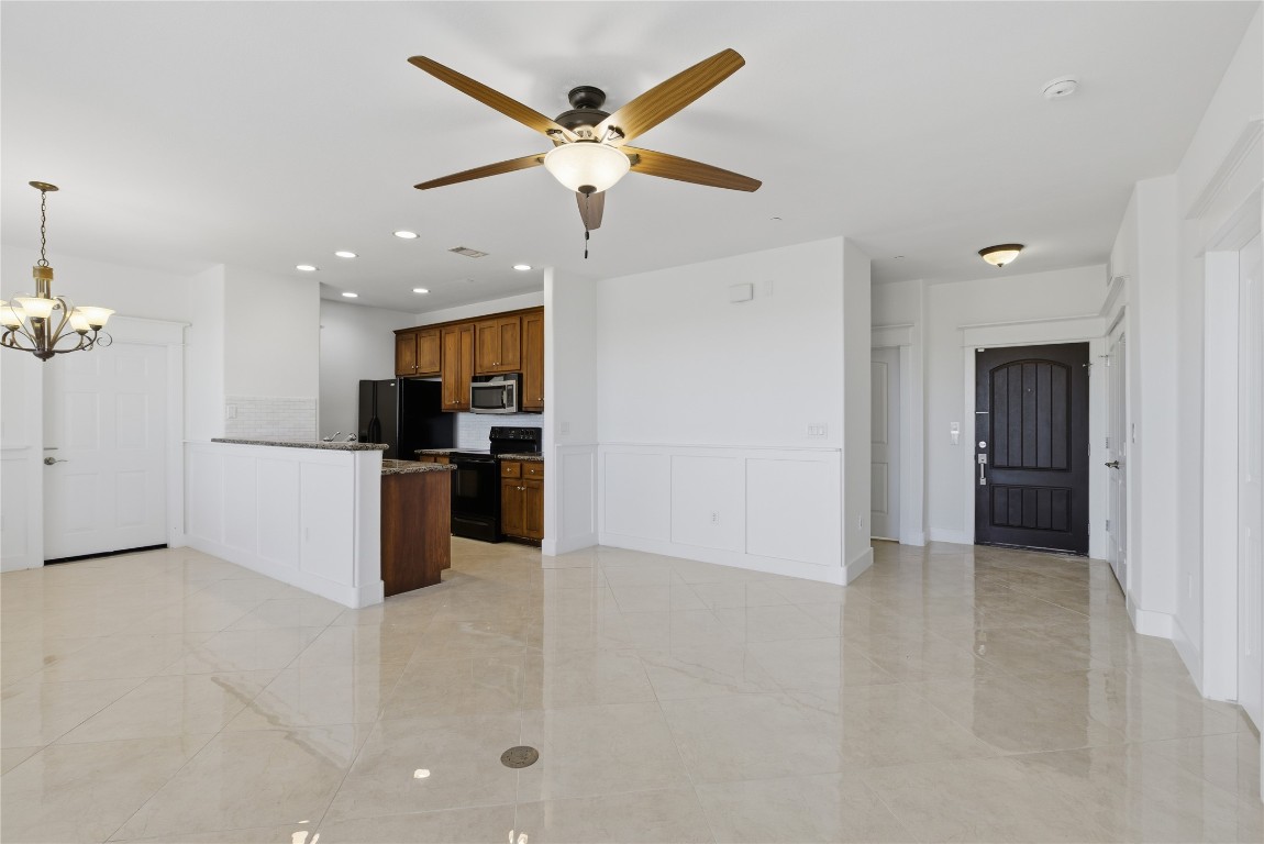 17700 Edgewood Way, Unit 101 Jonestown, TX 78645 - Photo 7 of 40 a view of kitchen with kitchen island stainless steel appliances refrigerator and a sink