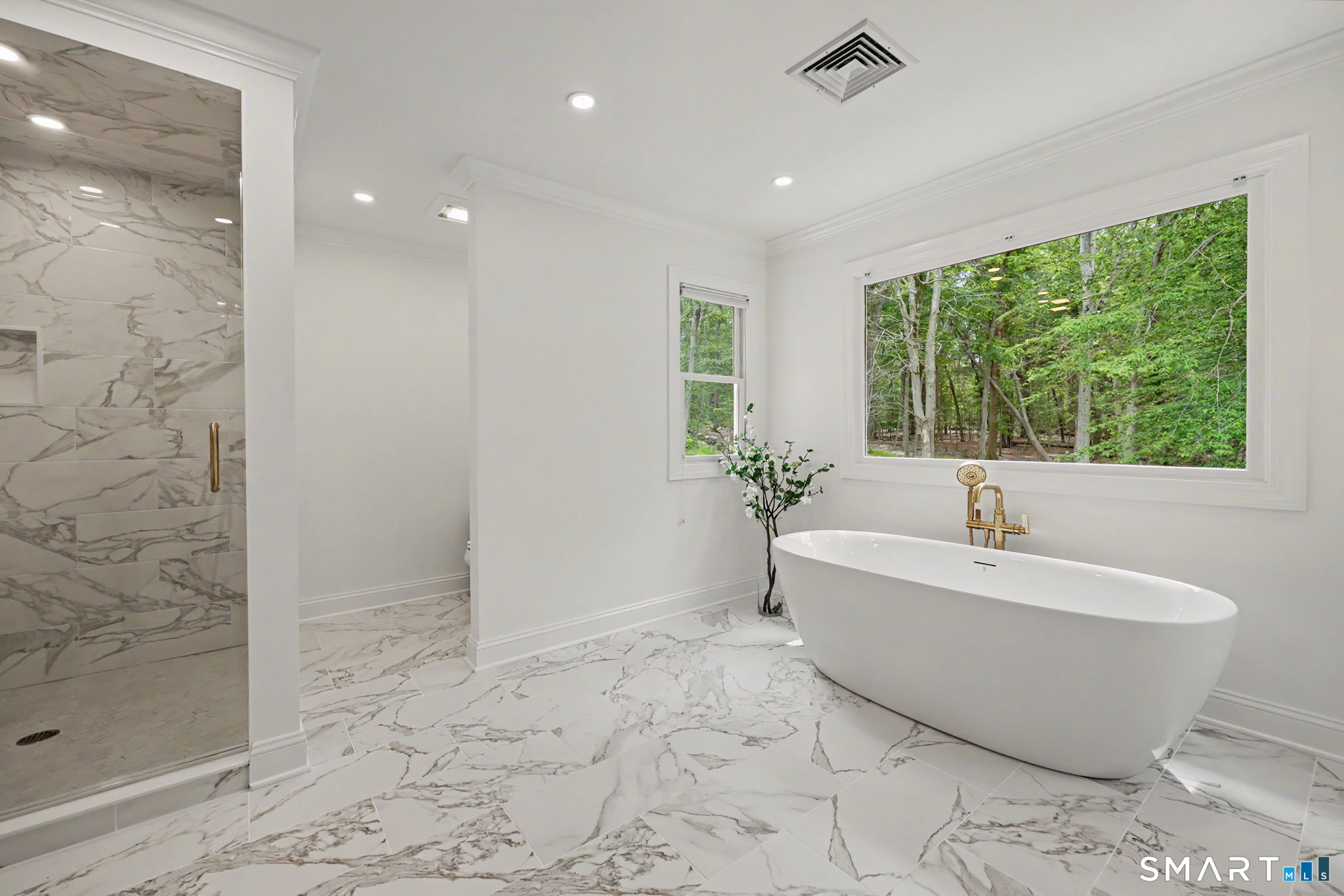 10 Side Hill Road Westport, CT 06880 - Photo 25 of 40 a white bath tub sitting in a spacious bathroom next to a window