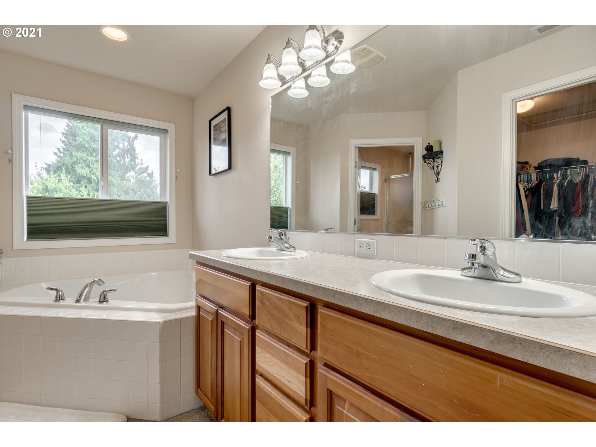 295 South Hillhurst Road Ridgefield, WA 98642 - Photo 13 of 32 a bathroom with a sink double vanity granite and a mirror