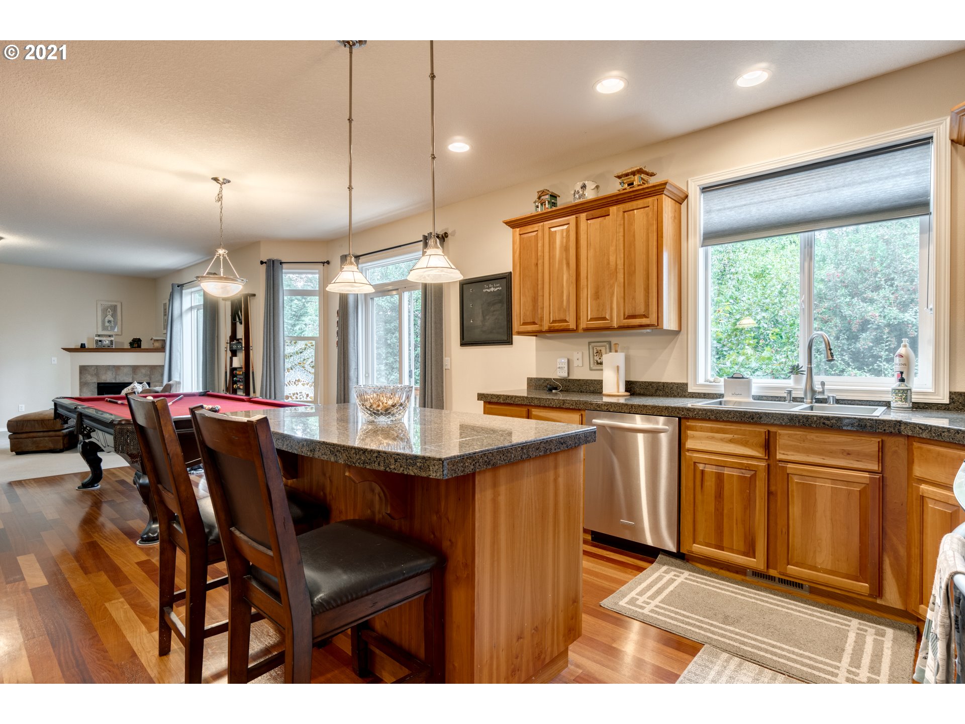 295 South Hillhurst Road Ridgefield, WA 98642 - Photo 8 of 32 a kitchen with stainless steel appliances granite countertop sink microwave and wooden cabinets