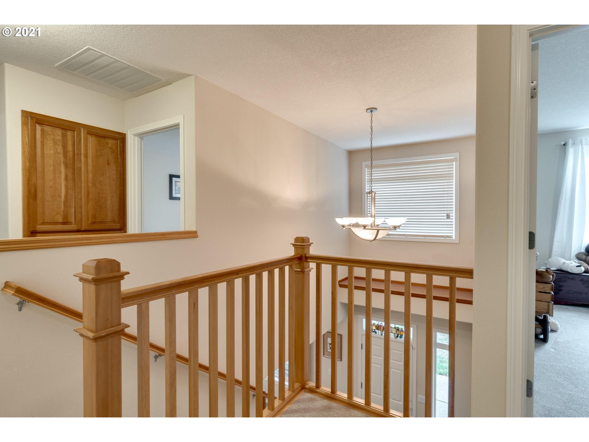295 South Hillhurst Road Ridgefield, WA 98642 - Photo 10 of 32 a view of a hallway with wooden floor and stairs