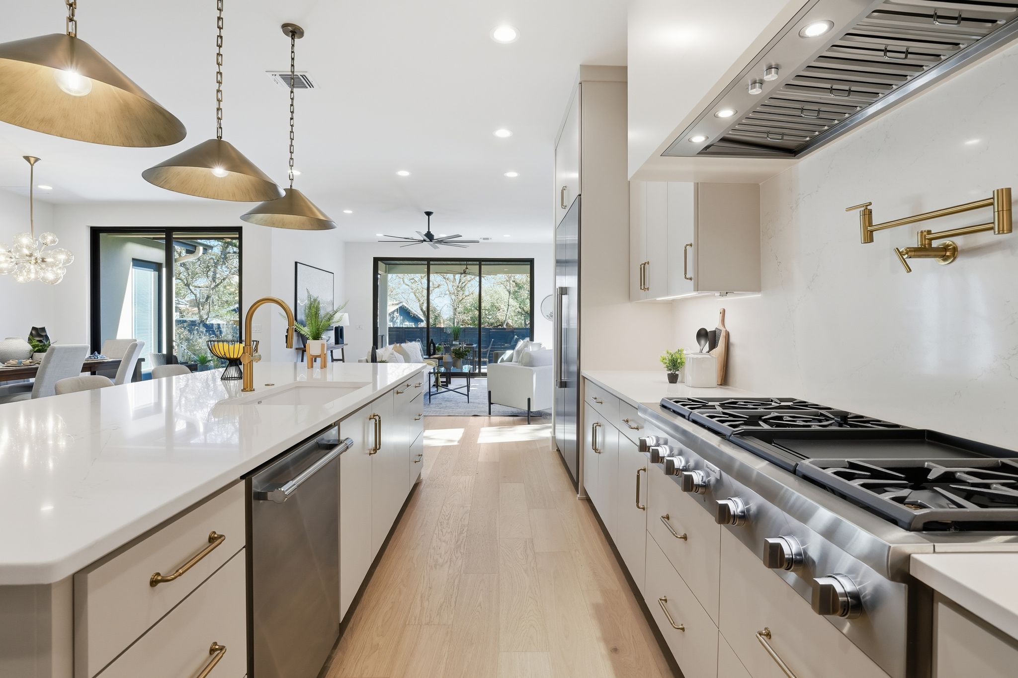 1607 Rabb Road Austin, TX 78704 - Photo 40 of 40 Kitchen with light wood finished floors, stainless steel appliances, open floor plan, and a spacious island
