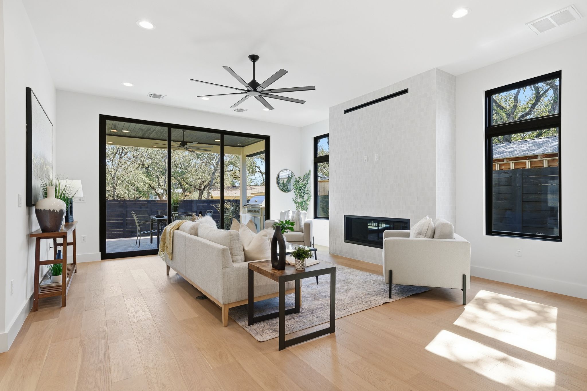 1607 Rabb Road Austin, TX 78704 - Photo 13 of 40 Living area featuring light wood-style floors, a large fireplace, ceiling fan, and recessed lighting