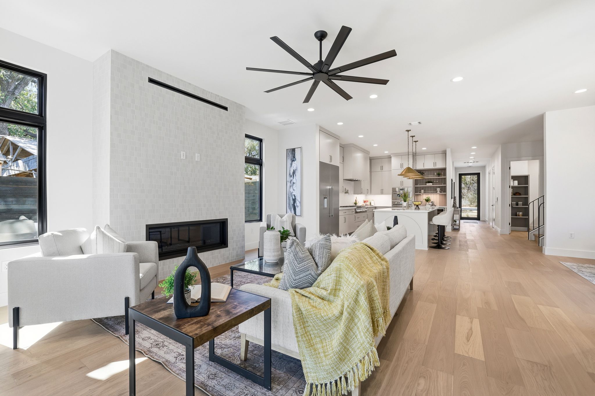 1607 Rabb Road Austin, TX 78704 - Photo 15 of 40 Living room with light wood-style flooring, a ceiling fan, a tile fireplace, and recessed lighting