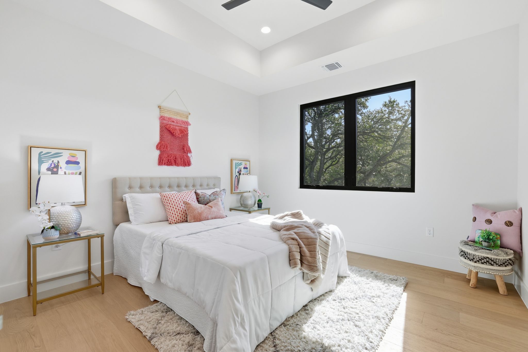 1607 Rabb Road Austin, TX 78704 - Photo 26 of 40 Bedroom featuring light wood-type flooring, a ceiling fan, and a tray ceiling
