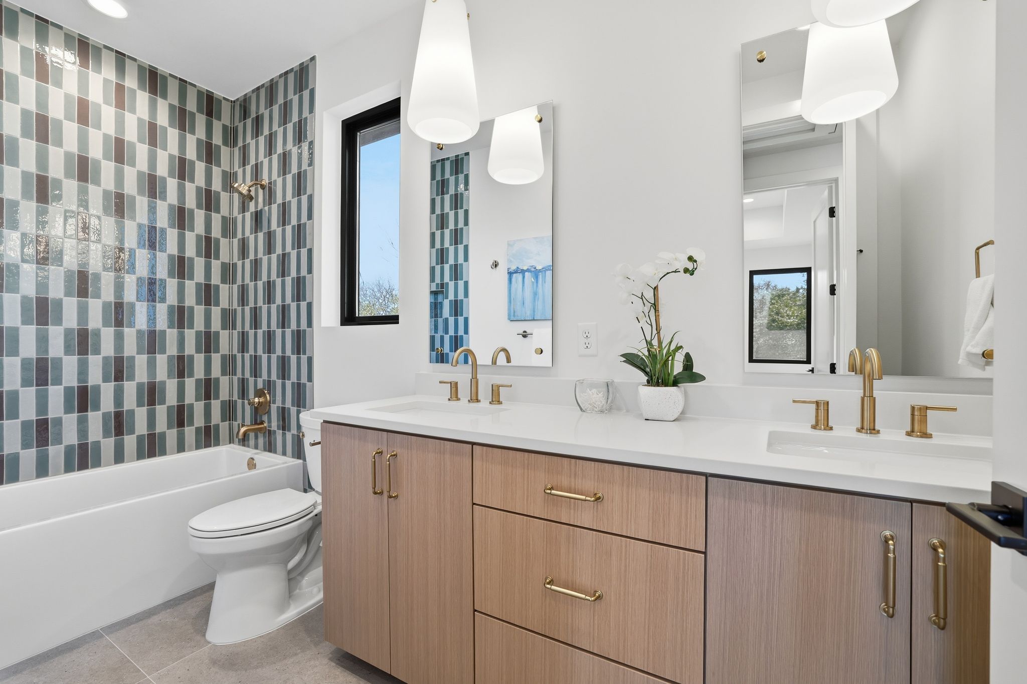 1607 Rabb Road Austin, TX 78704 - Photo 27 of 40 Bathroom featuring double vanity, bathtub / shower combination, and light tile patterned flooring