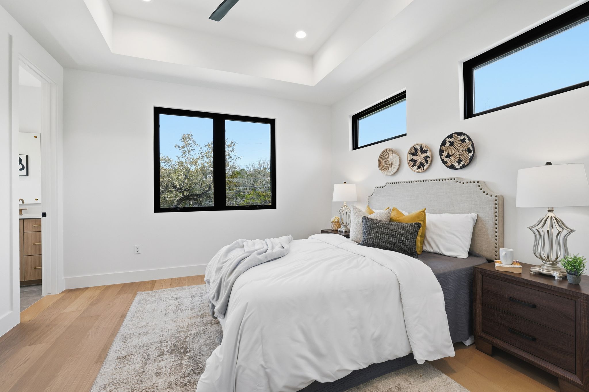 1607 Rabb Road Austin, TX 78704 - Photo 29 of 40 Bedroom featuring light wood-type flooring, a raised ceiling, ceiling fan, and recessed lighting