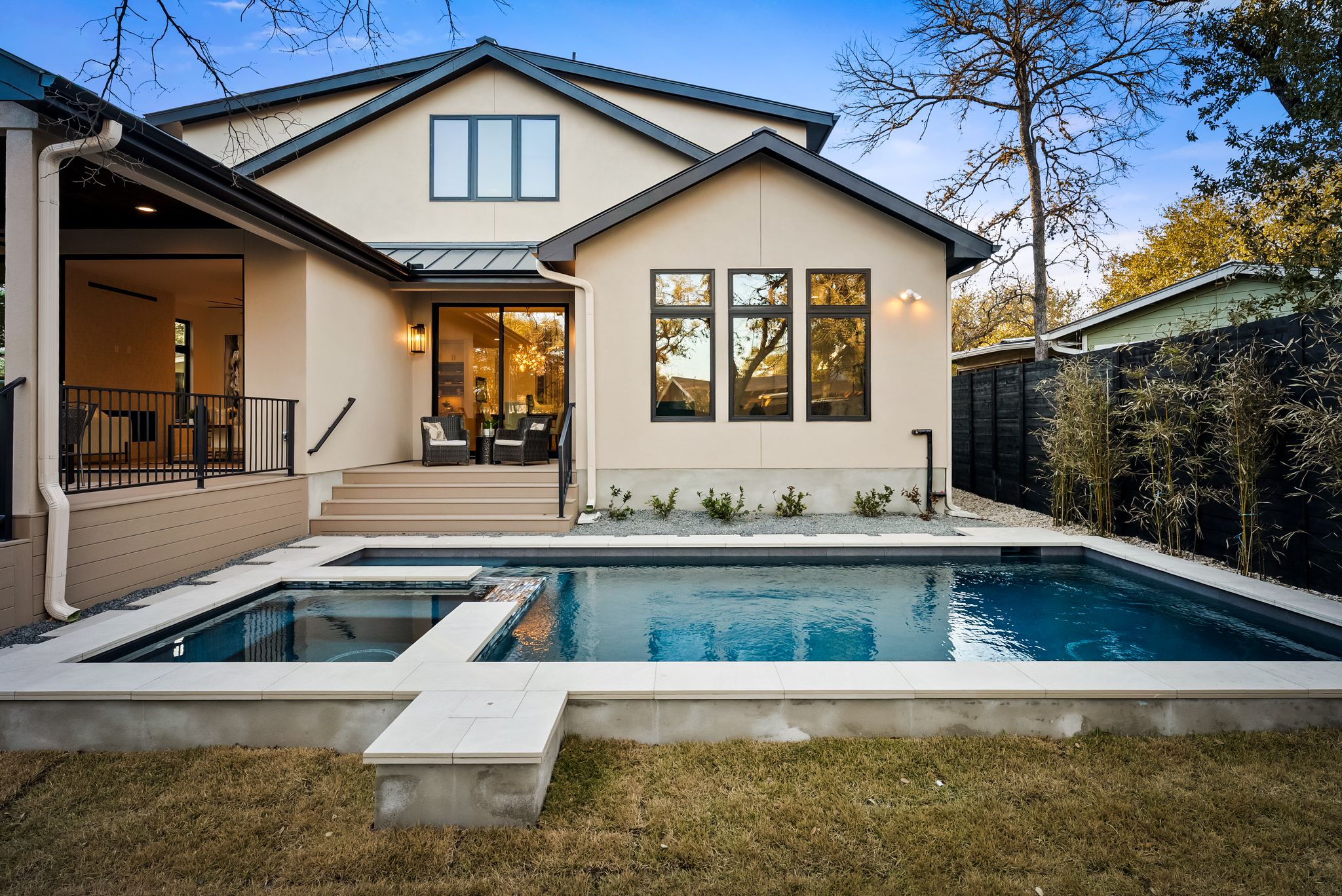 1607 Rabb Road Austin, TX 78704 - Photo 34 of 40 Back of property with a standing seam roof, a patio area, stucco siding, and a pool with connected hot tub