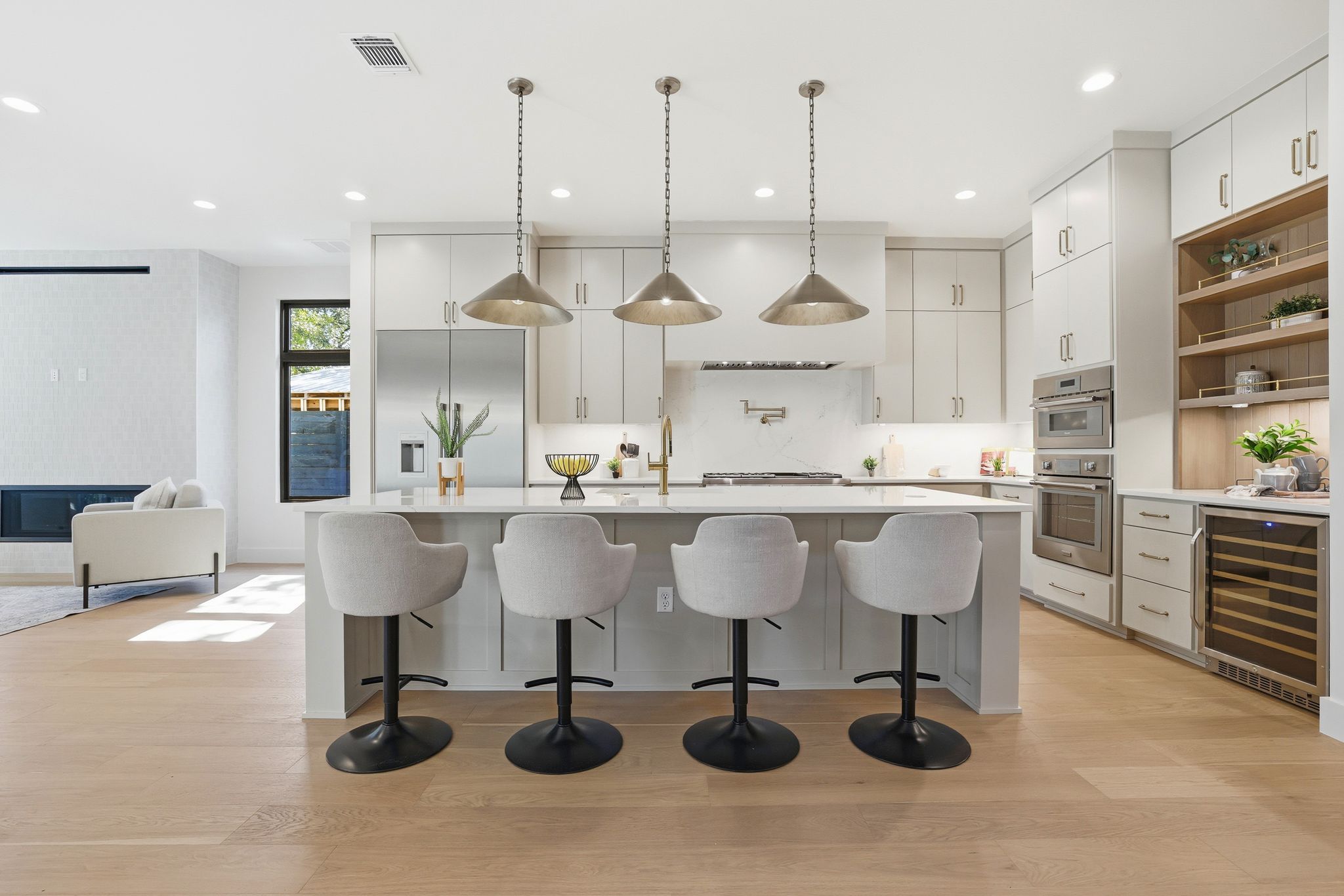 1607 Rabb Road Austin, TX 78704 - Photo 8 of 40 Kitchen featuring open shelves, hanging light fixtures, wine cooler, light wood finished floors, and white cabinetry