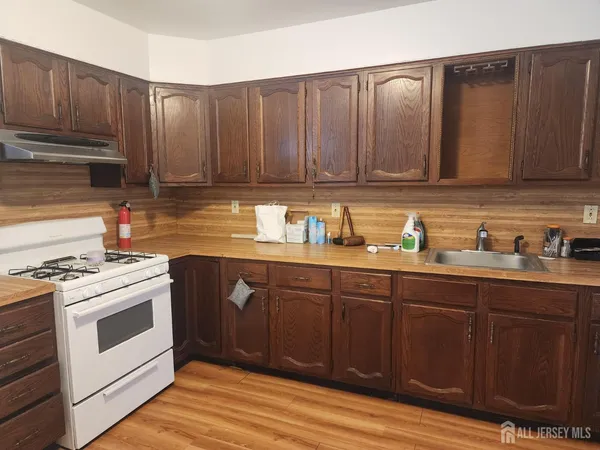 a kitchen with wooden cabinets and white appliances