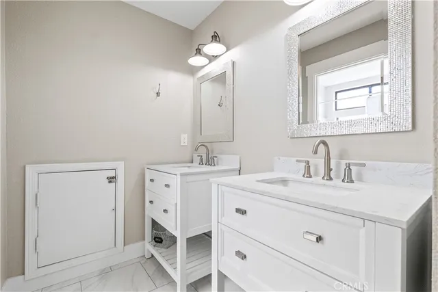 a spacious bathroom with a double vanity sink mirror and