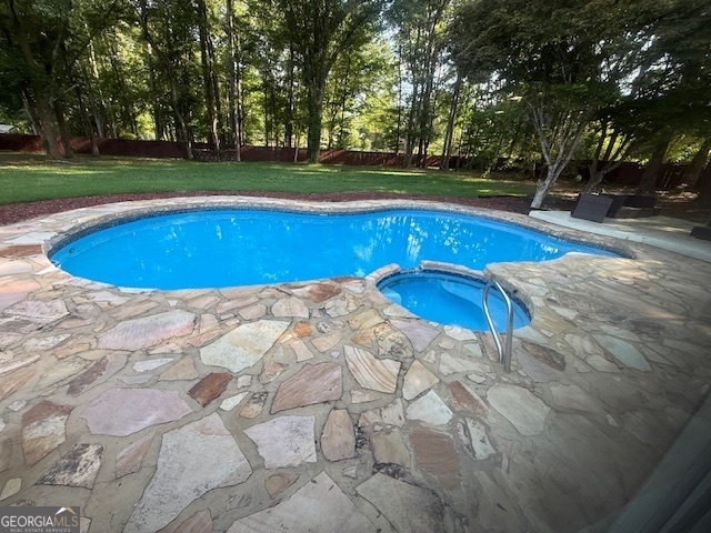 558 Kenwood Road Fayetteville, GA 30214 - Photo 5 of 33 a view of a swimming pool with an outdoor space and seating area