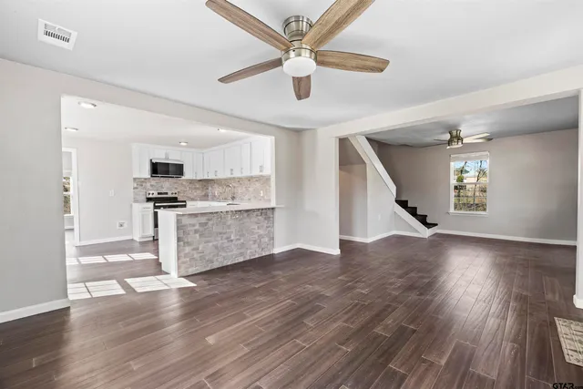 a view of kitchen with cabinets and wooden floor