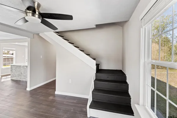 a view of entryway and hall with wooden floor