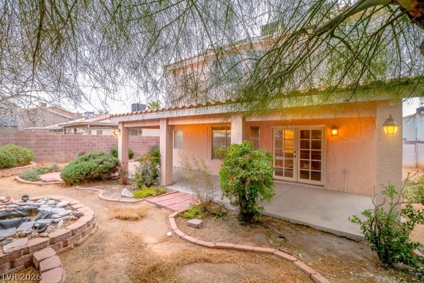 1429 Hawkwood Road Henderson, NV 89014 - Photo 39 of 53 A spacious covered patio spans the rear facade, overlooking a textured desert backyard.
