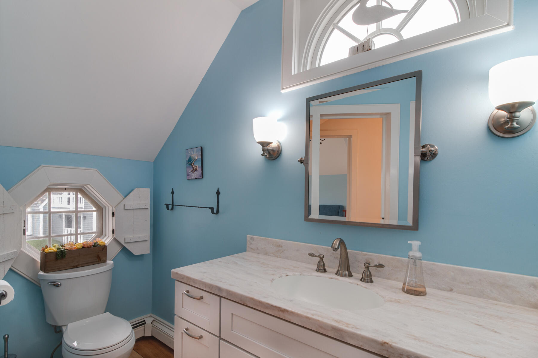 15 Brant Rock Road, Unit 765 Mashpee, MA 02649 - Photo 12 of 17 a bathroom with a toilet a sink and mirror