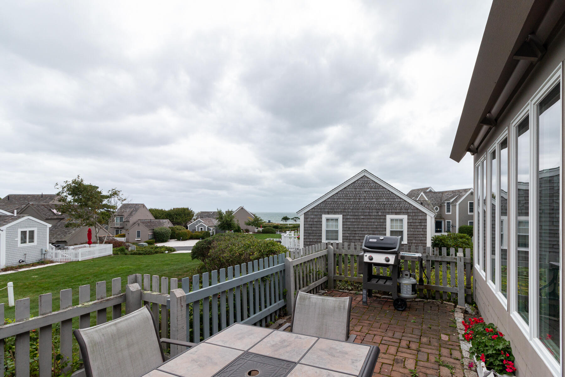 15 Brant Rock Road, Unit 765 Mashpee, MA 02649 - Photo 14 of 17 a view of a house with backyard and porch
