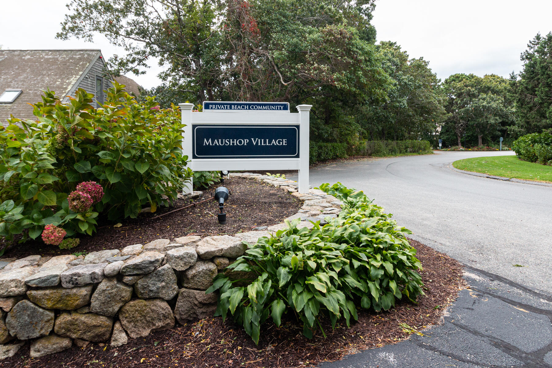 15 Brant Rock Road, Unit 765 Mashpee, MA 02649 - Photo 17 of 17 a sign that is sitting in front of flowers