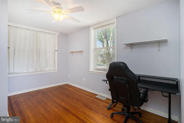 a view of a workspace with furniture and a window