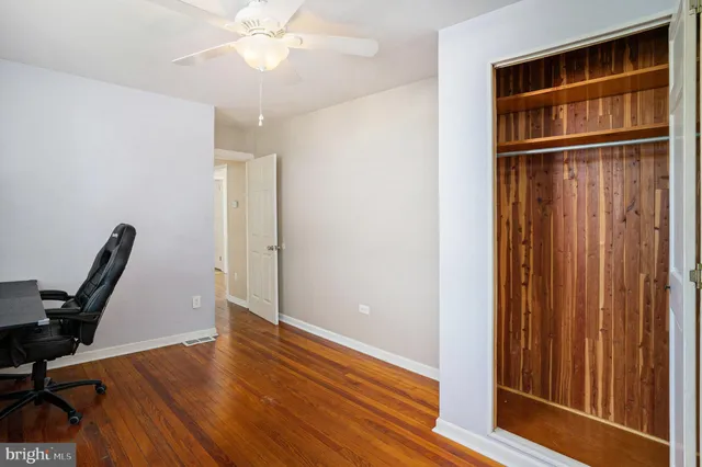 a view of a workspace with furniture and wooden floor