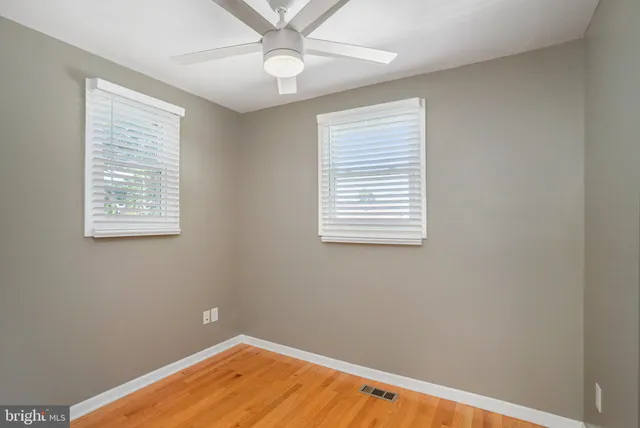 a view of a room with wooden floor and windows