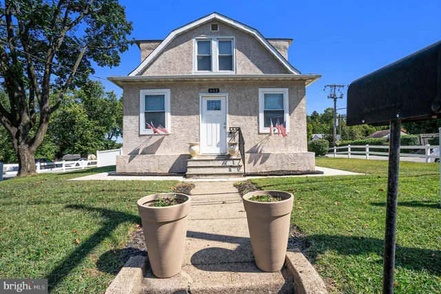 a front view of a house with garden and porch