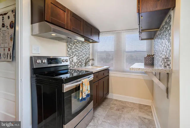 a kitchen with stainless steel appliances granite countertop a stove and a refrigerator