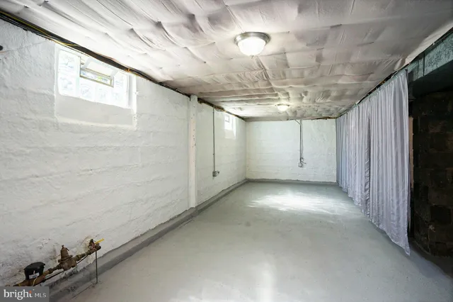 a view of a livingroom with a ceiling fan and window