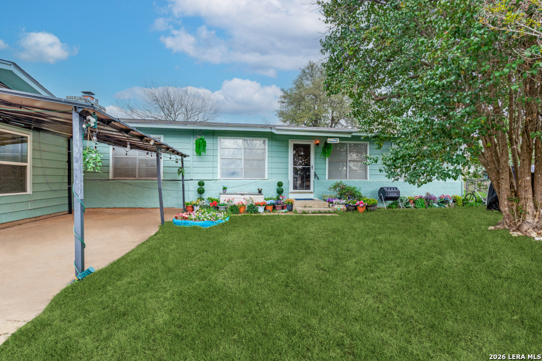 a view of a backyard with table and chairs and potted plants