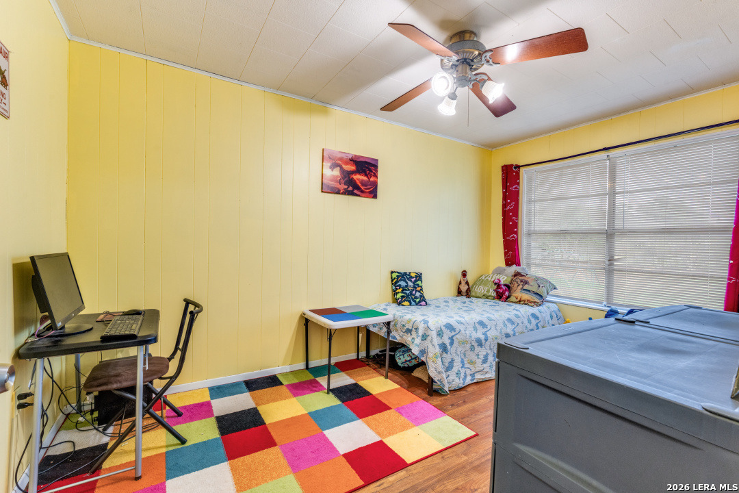 914 6th Street Blanco, TX 78606 - Photo 16 of 26 a bedroom with a bed and a table in it