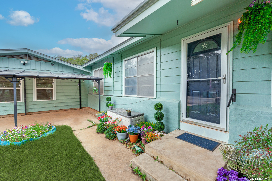 914 6th Street Blanco, TX 78606 - Photo 2 of 26 a front view of a house with a garden