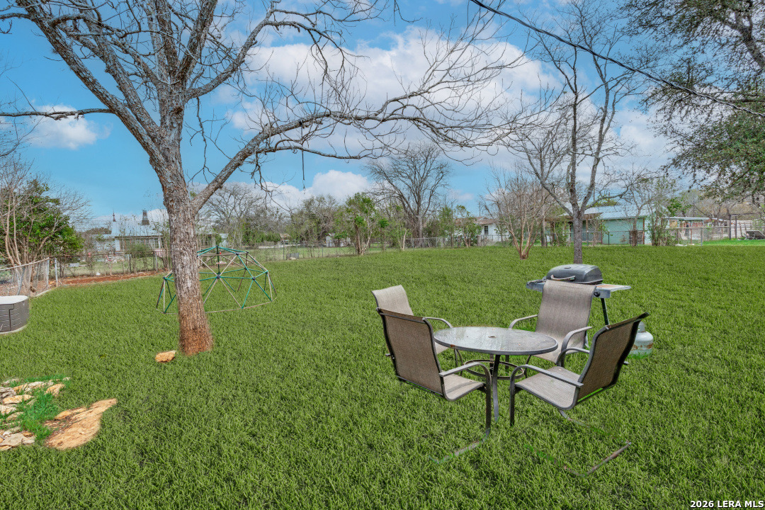 914 6th Street Blanco, TX 78606 - Photo 21 of 26 a table and chairs in the garden