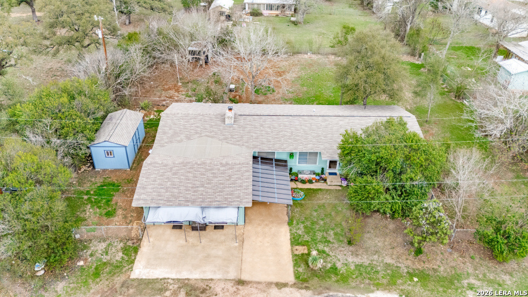 914 6th Street Blanco, TX 78606 - Photo 24 of 26 an aerial view of a house with a yard and trees all around