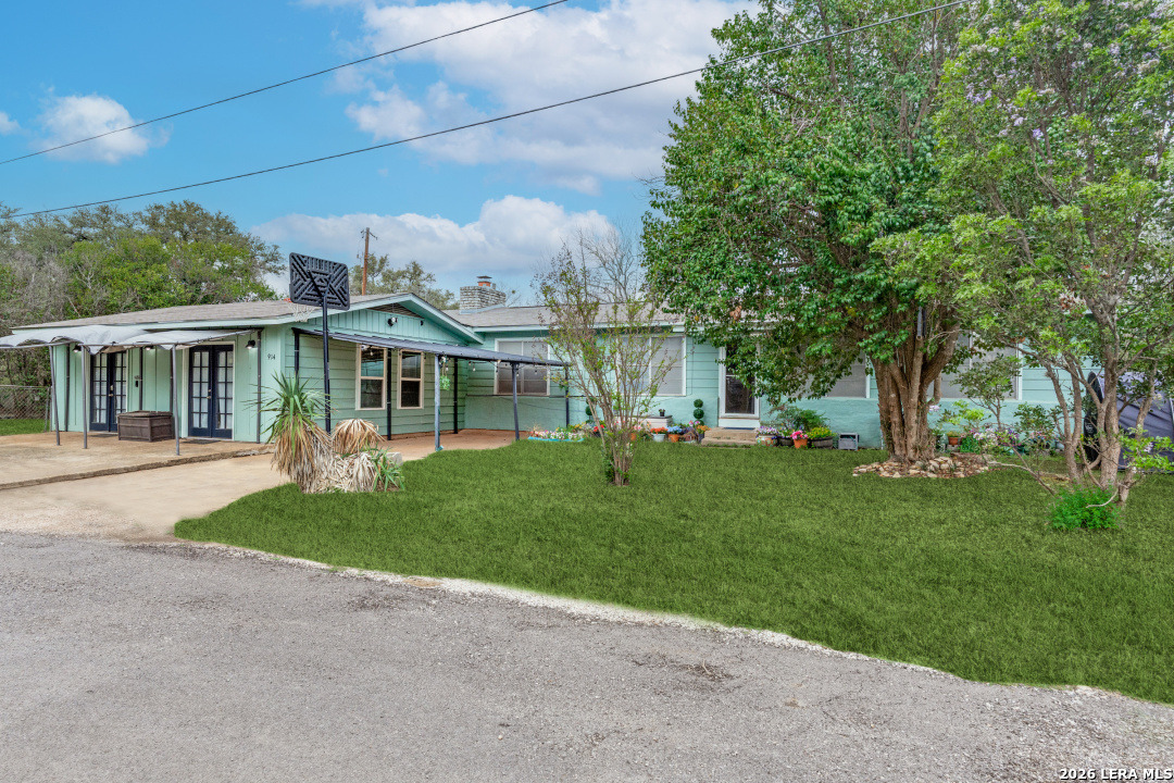 914 6th Street Blanco, TX 78606 - Photo 3 of 26 a front view of a house with a yard